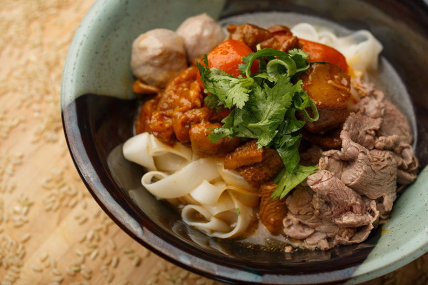 Trio of beef: sliced tenderloin, beef ball and beef stew over large rice noodle